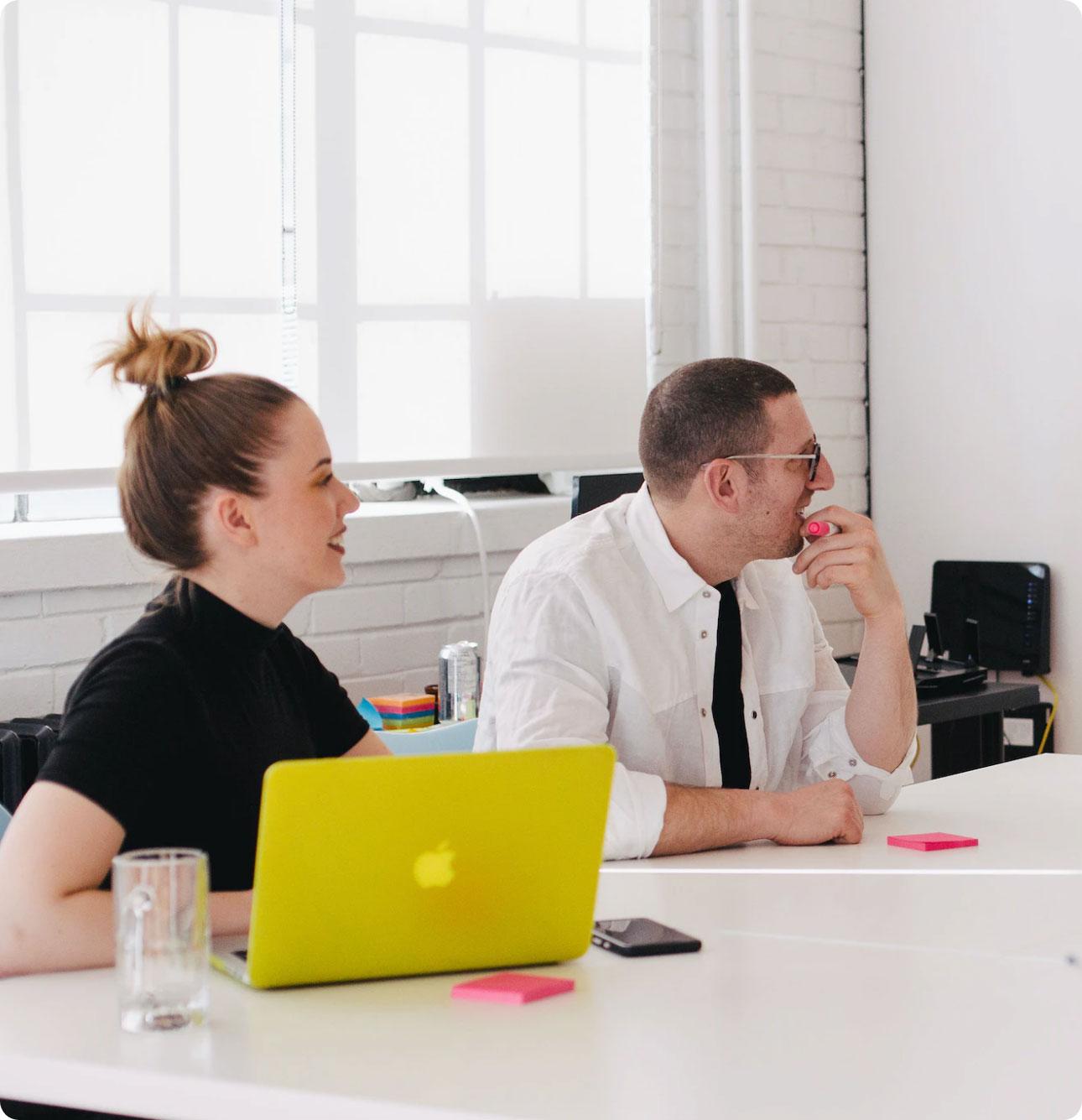 Man and woman sat in a meeting room